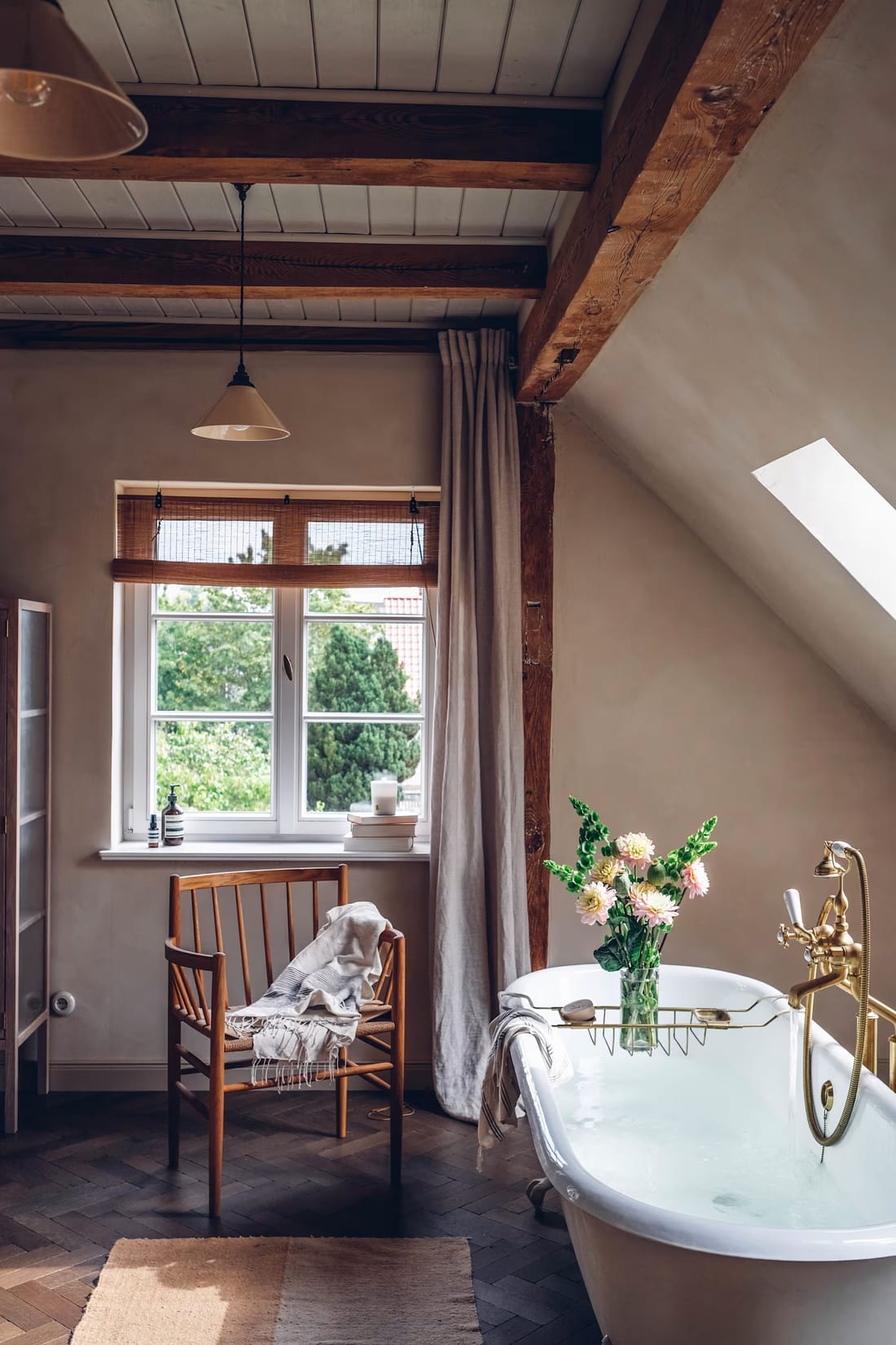 A wood window in a cozy attic bathroom