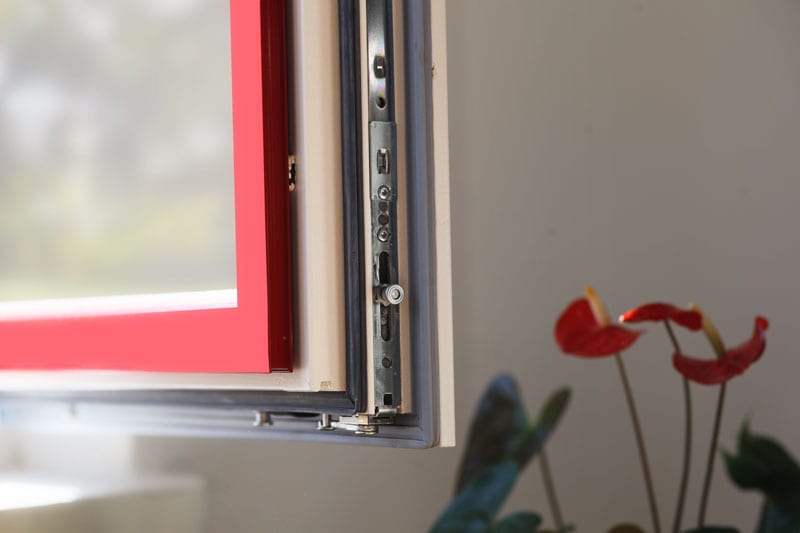 Detail of wood-aluminum window hardware and glazing