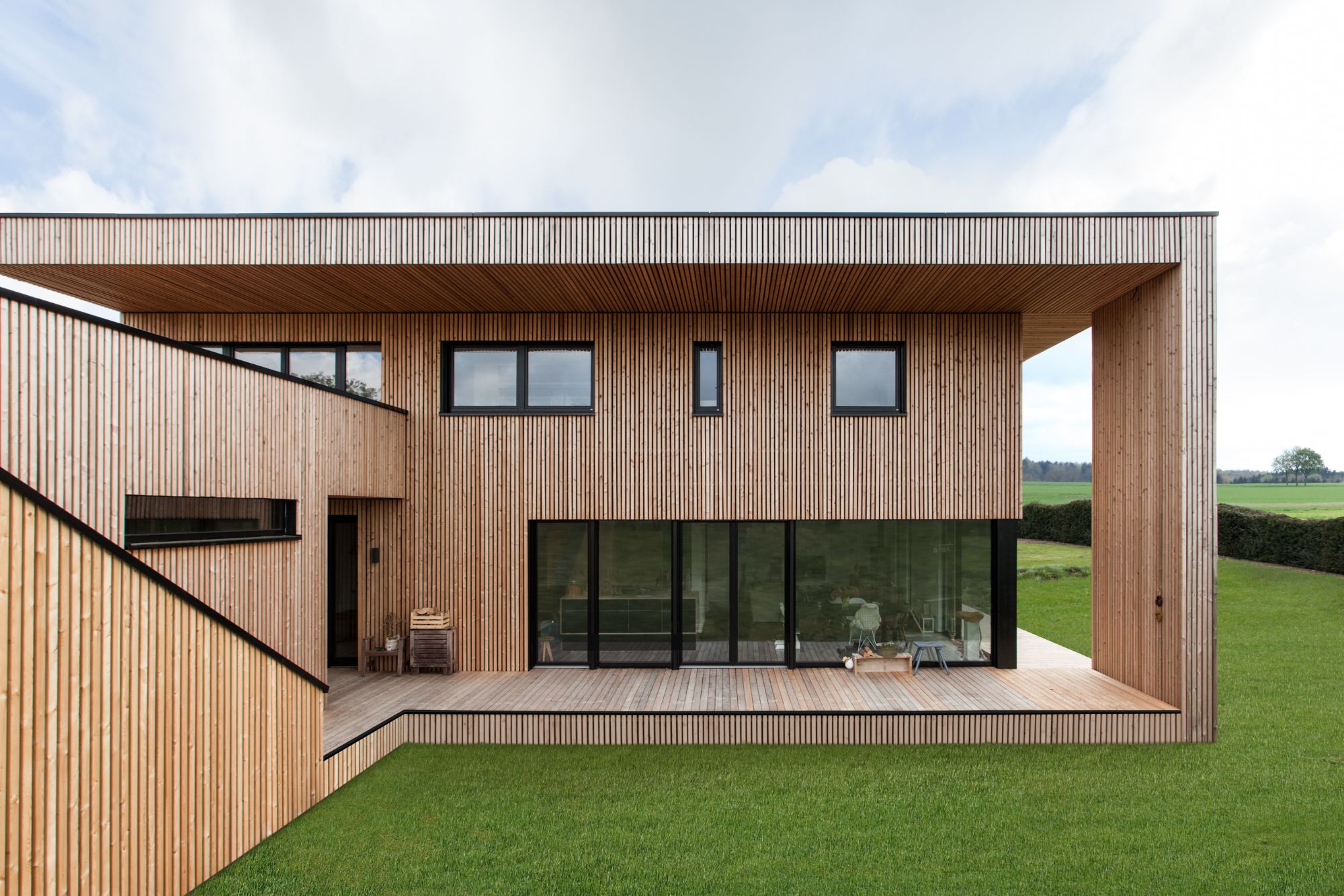 Modern home with wood-clad exterior and large wood windows