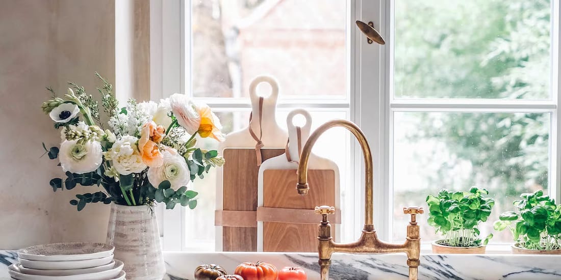A multi-pane wood window behind a kitchen counter